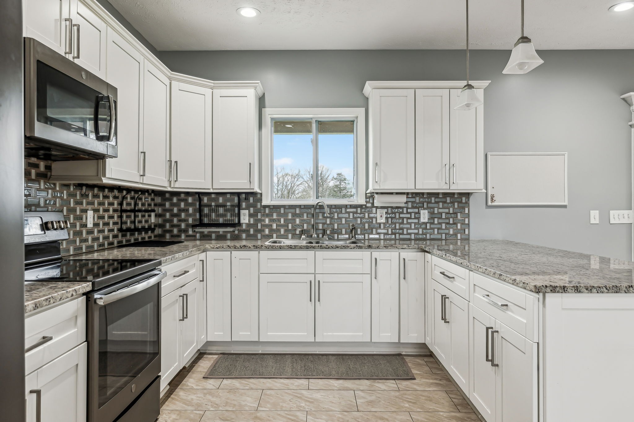4618 Simmons Bluff Road Lebanon, TN 37090 - Photo 4 of 35 a kitchen with granite countertop white cabinets stainless steel appliances and a sink