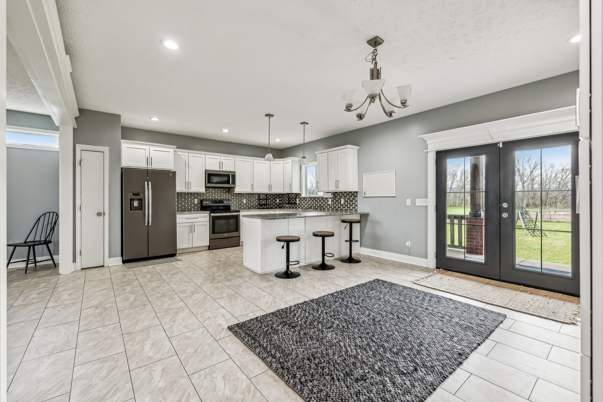 4618 Simmons Bluff Road Lebanon, TN 37090 - Photo 5 of 35 a open kitchen with stainless steel appliances kitchen island granite countertop a refrigerator and a sink