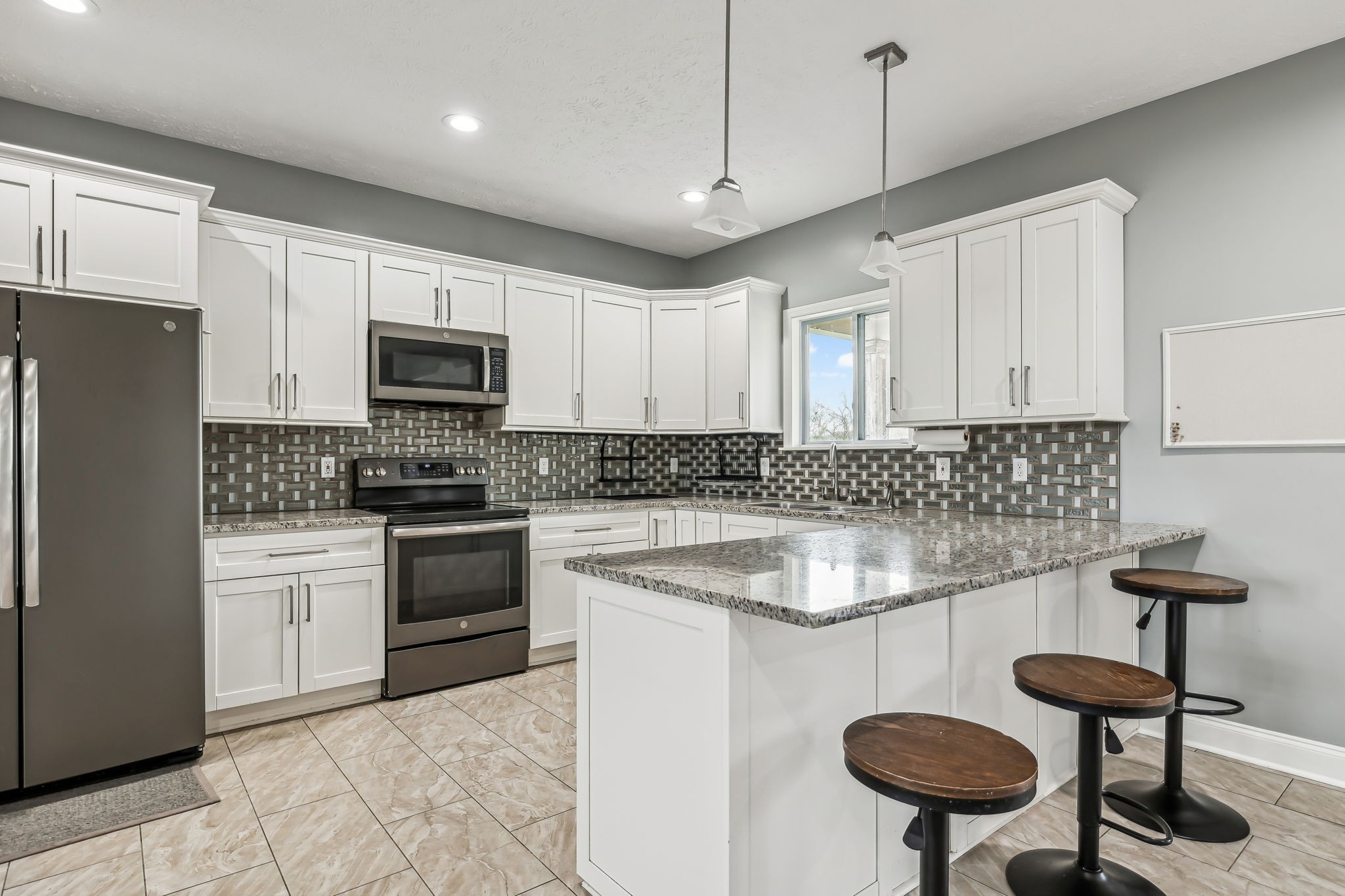 4618 Simmons Bluff Road Lebanon, TN 37090 - Photo 6 of 35 a kitchen with stainless steel appliances granite countertop a sink a stove a refrigerator and island with wooden floor
