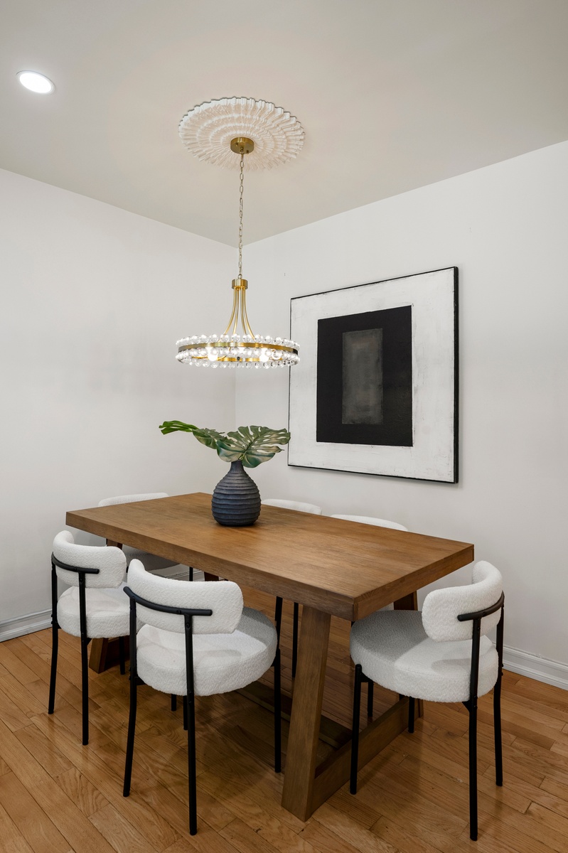 237 East 88th Street, Unit 101 Manhattan, NY 10128 - Photo 6 of 17 a view of a dining room with furniture and wooden floor