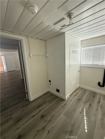 a view of a room with wooden floor and windows