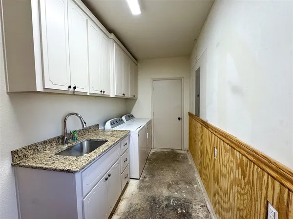 a kitchen with a sink a stove and cabinets