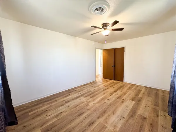 a view of a room with a ceiling fan