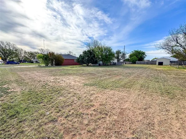 a view of a field with an trees