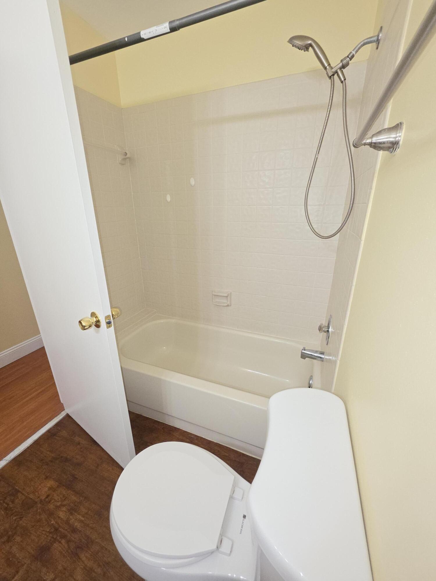 401 Springdale Circle Palm Springs, FL 33461 - Photo 14 of 31 a bathroom with a toilet and a shower
