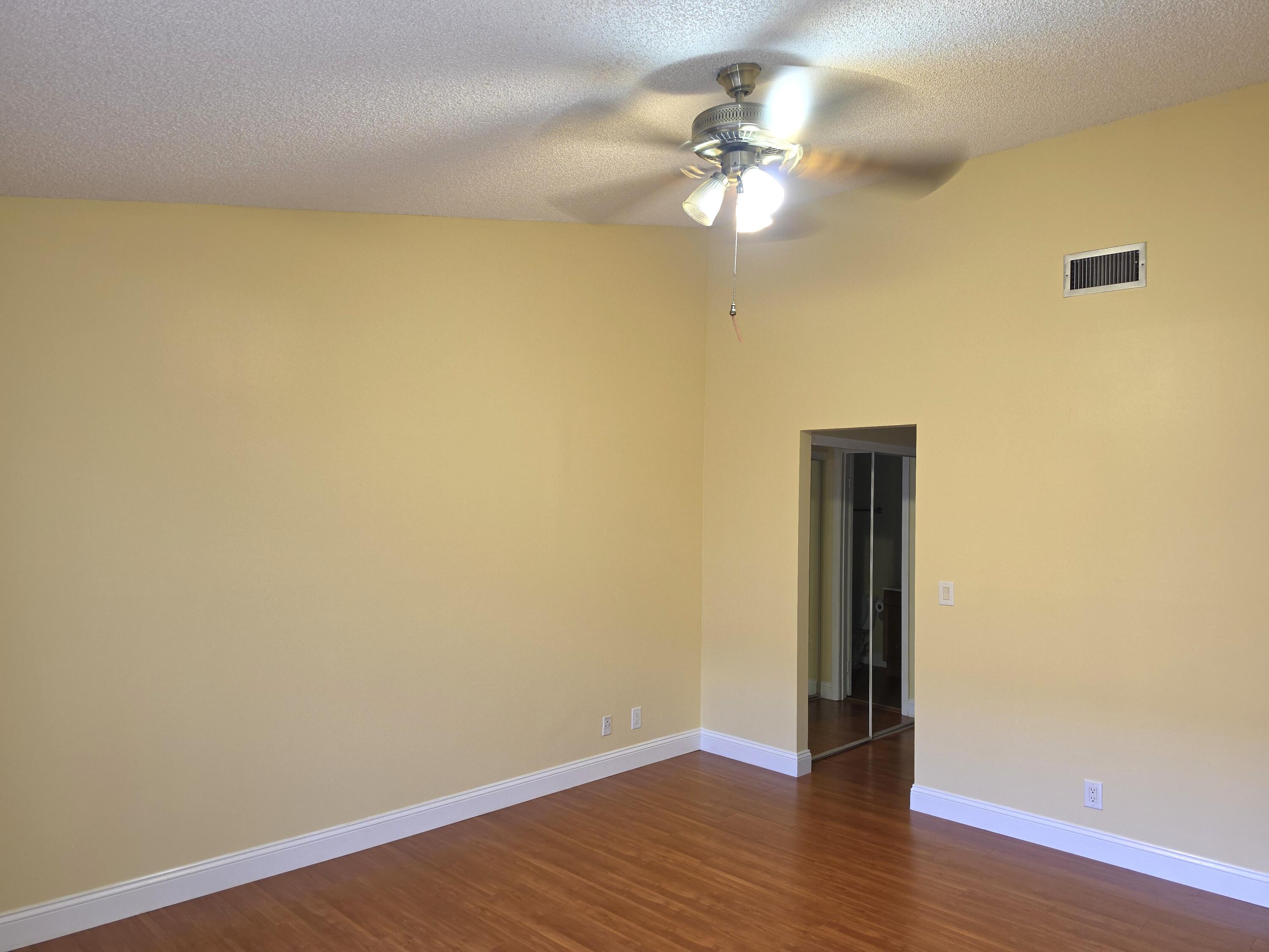 401 Springdale Circle Palm Springs, FL 33461 - Photo 18 of 31 a view of an empty room with wooden floor