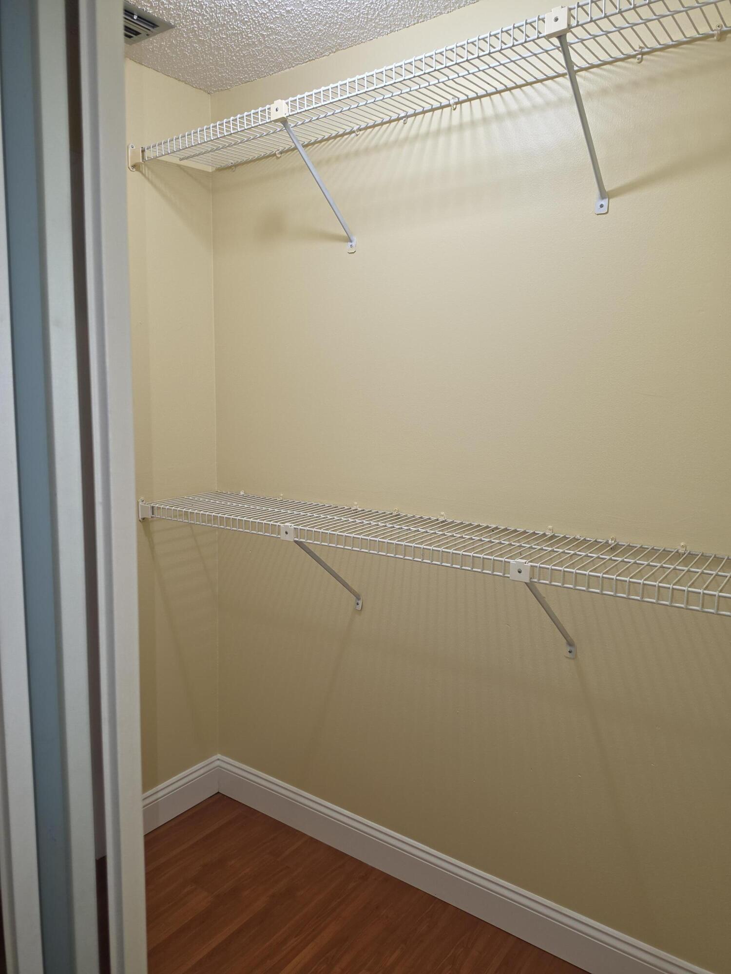 401 Springdale Circle Palm Springs, FL 33461 - Photo 19 of 31 a view of a room with racks on the wall