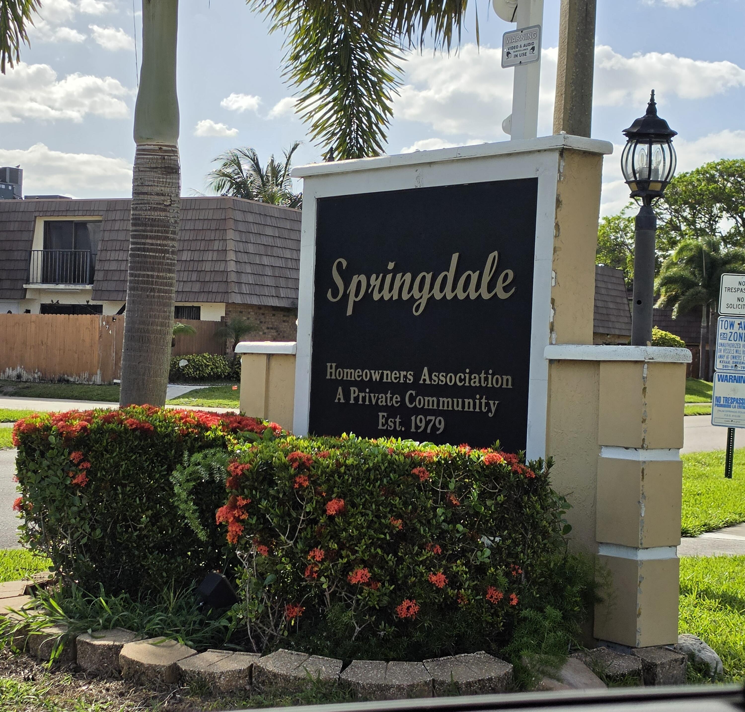 401 Springdale Circle Palm Springs, FL 33461 - Photo 23 of 31 a sign on the side of a building
