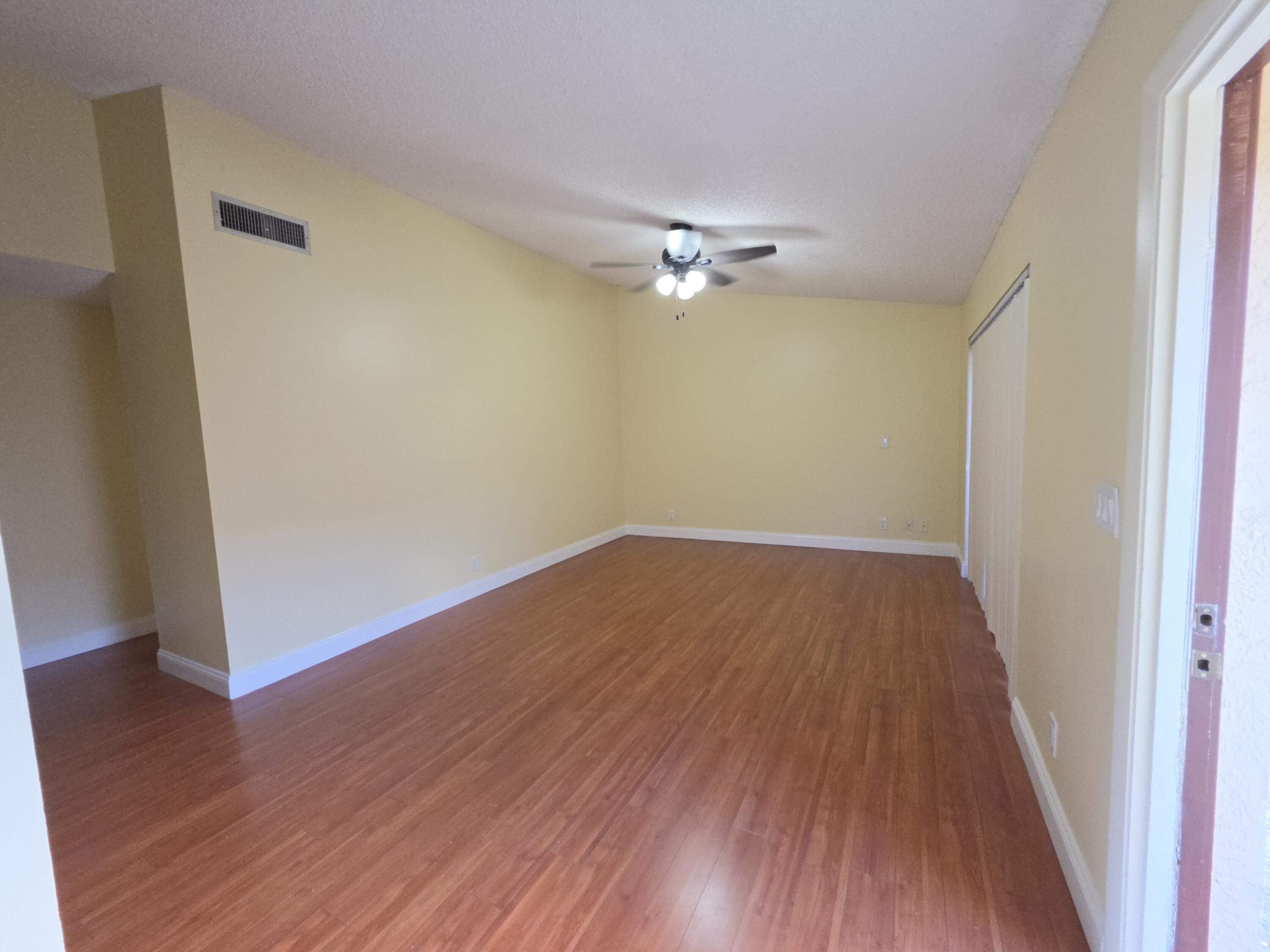 401 Springdale Circle Palm Springs, FL 33461 - Photo 5 of 31 a view of empty room with wooden floor