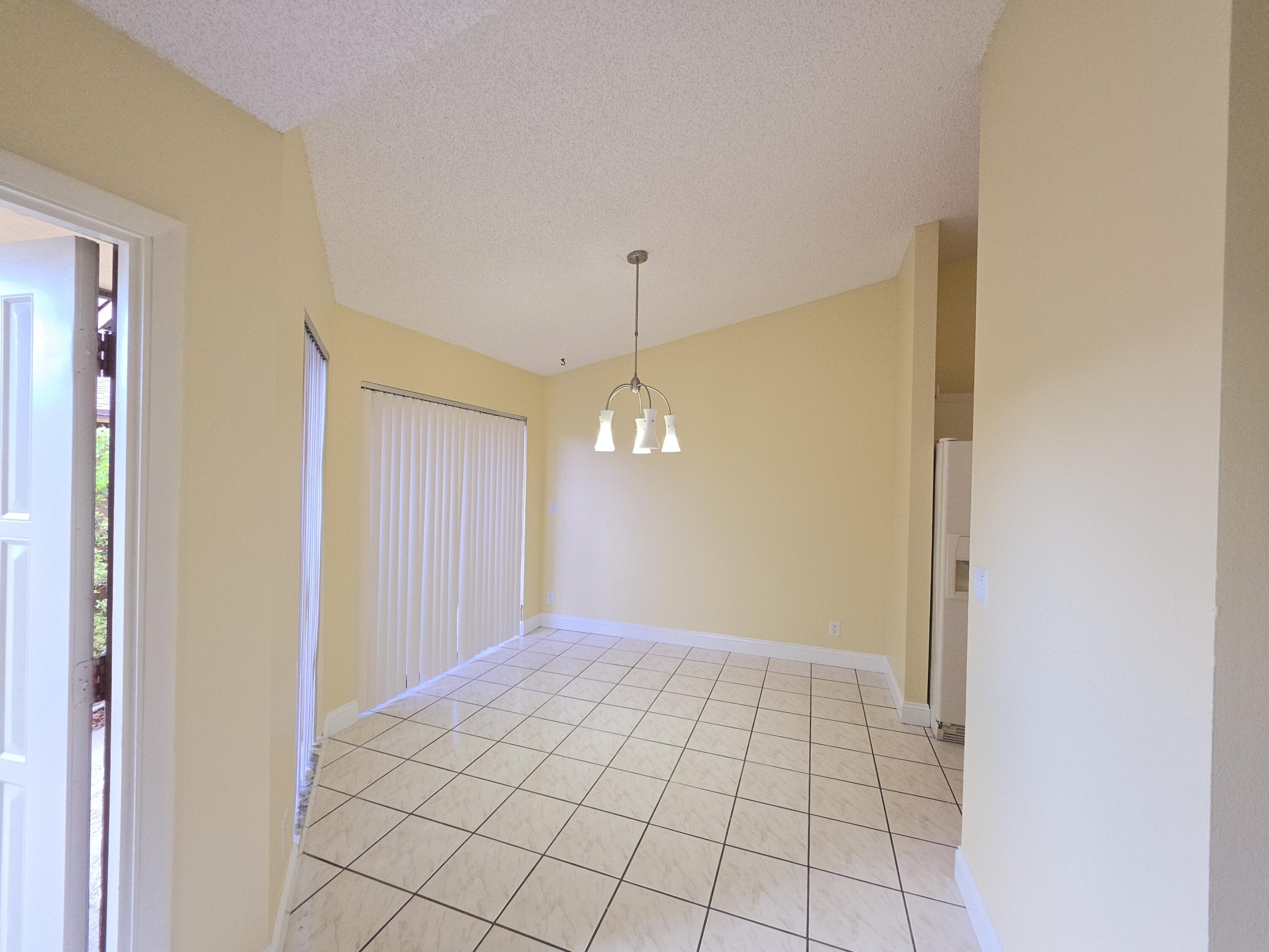 401 Springdale Circle Palm Springs, FL 33461 - Photo 6 of 31 a view of empty room with window and chandelier fan