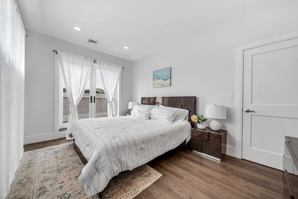 a bedroom with a bed and a mirror