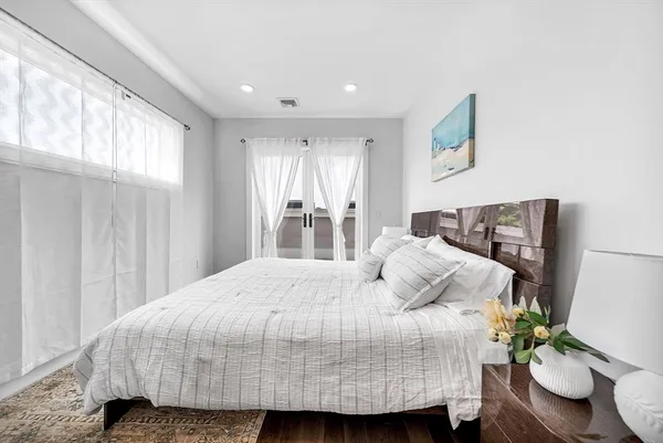 a bedroom with a bed and window