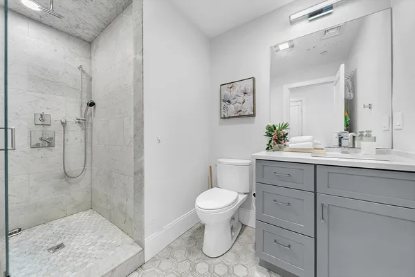 a bathroom with a sink toilet and shower
