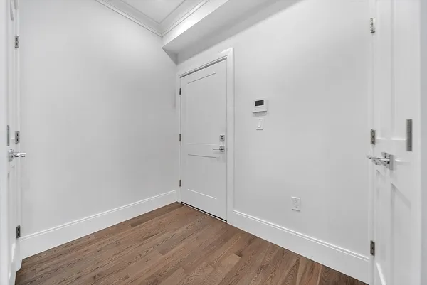 a view of a room with wooden floor