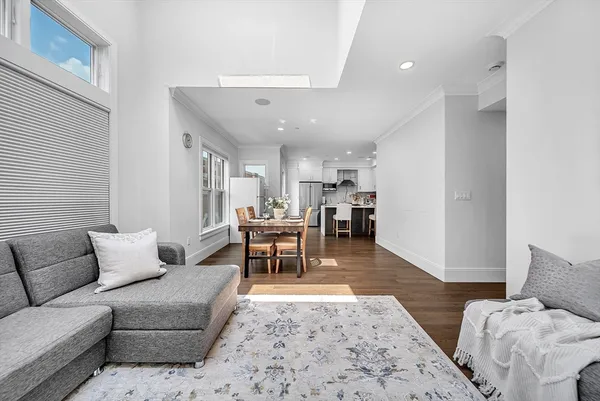 a living room with furniture and view of kitchen