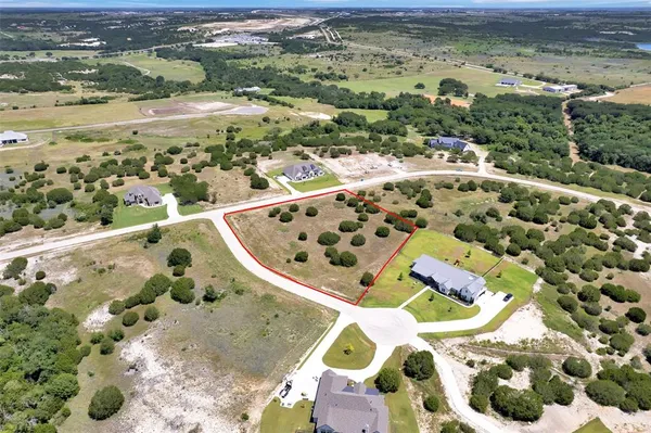 an aerial view of a swimming pool and mountain view in back