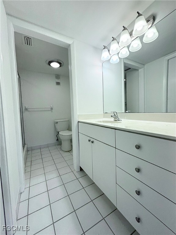 2264 Winkler Avenue, Unit 107 Fort Myers, FL 33901 - Photo 13 of 17 a spacious bathroom with a double vanity sink mirror and toilet