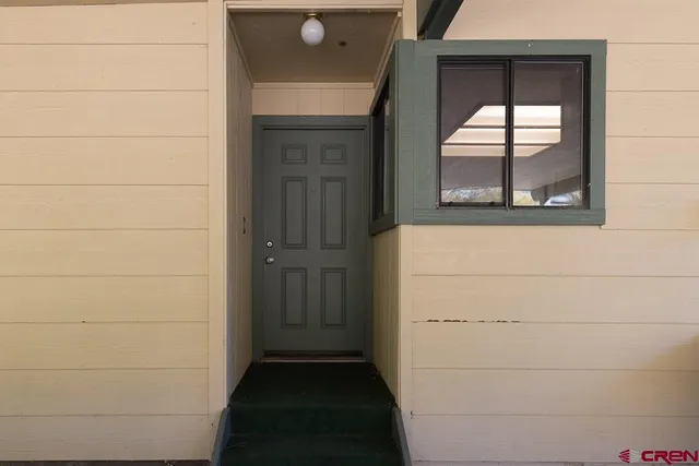 a view of a room with appliances cabinets and furniture