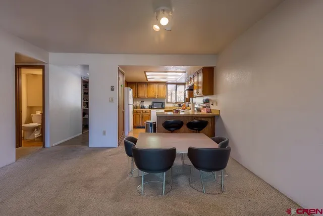 a kitchen with stainless steel appliances granite countertop a sink dishwasher stove and cabinets with wooden floor