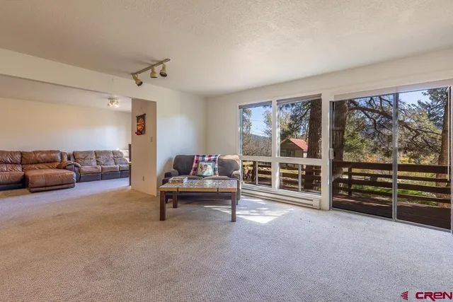a living room with furniture and a piano