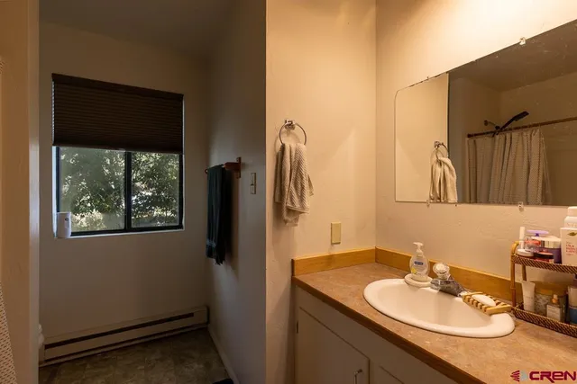 a view of a bedroom with a window and a flat screen tv