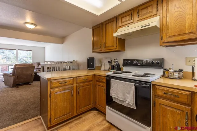 a kitchen with stainless steel appliances granite countertop a stove and a sink