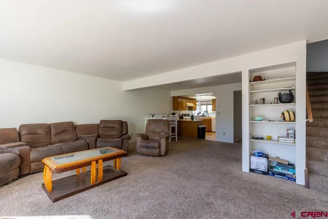 a living room with furniture and gym equipment