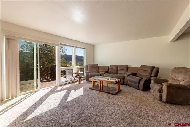 a living room with furniture and large windows