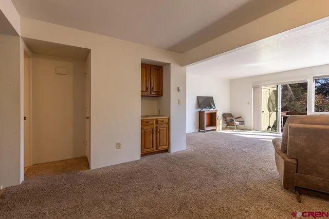 a view of a livingroom with furniture and windows