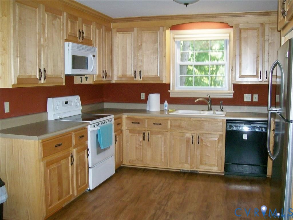 1243 Peck Road North Chesterfield, VA 23235 - Photo 11 of 19 a kitchen with a stove sink and cabinets