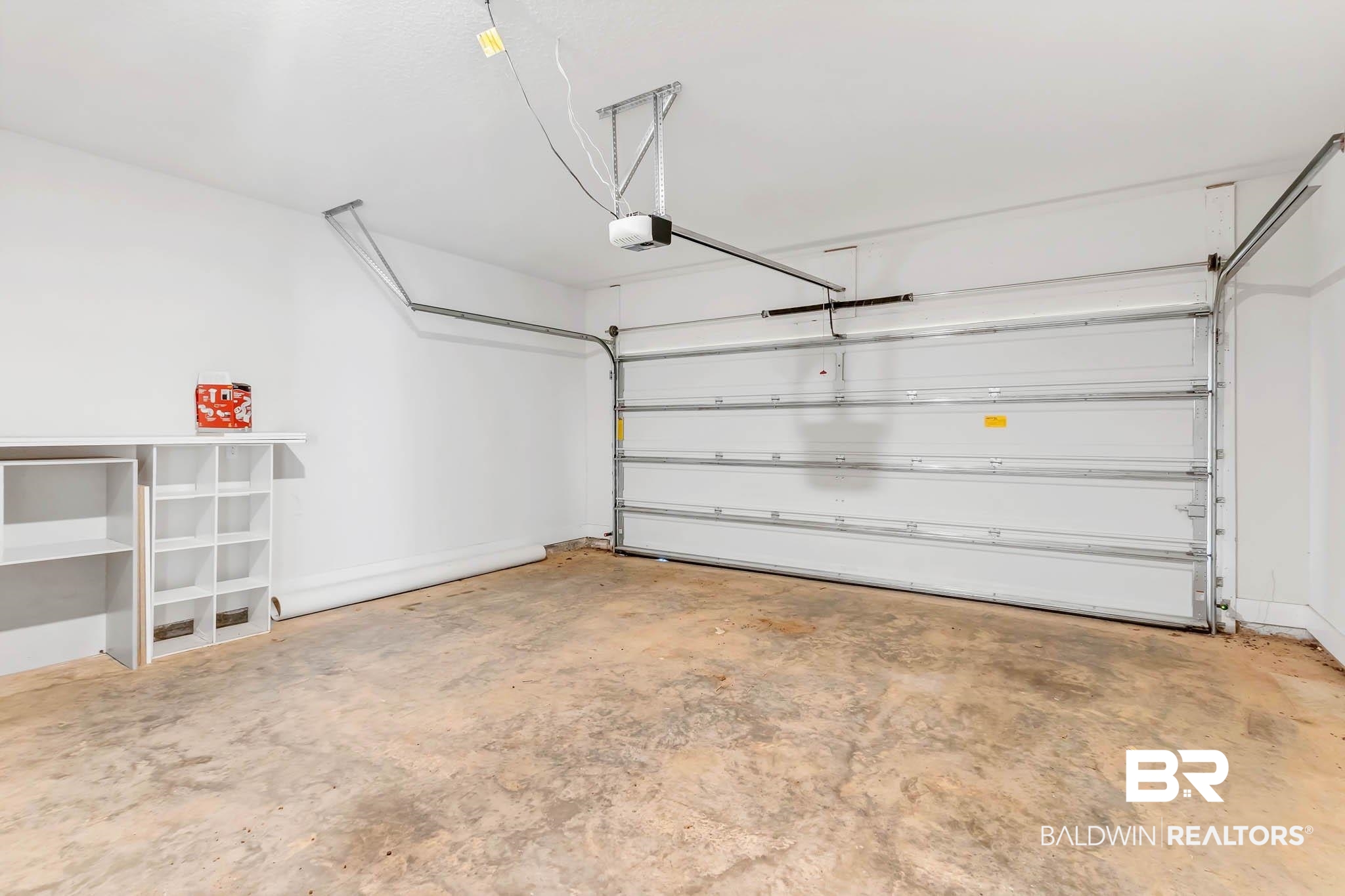 16461 Prado Loop Loxley, AL 36551 - Photo 53 of 78 Garage with baseboards and a garage door opener