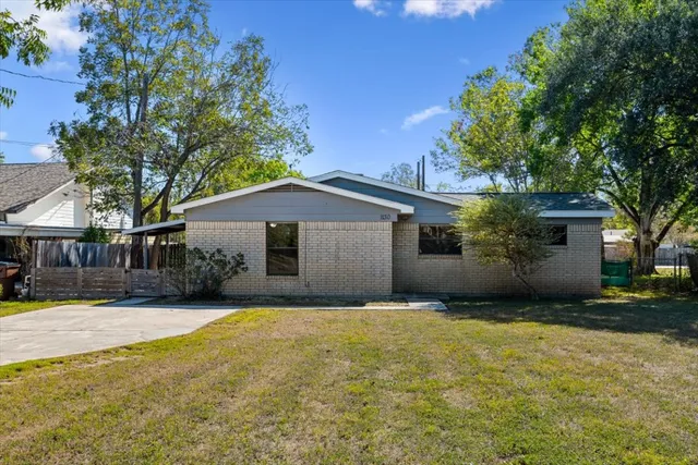 a front view of house with yard and trees