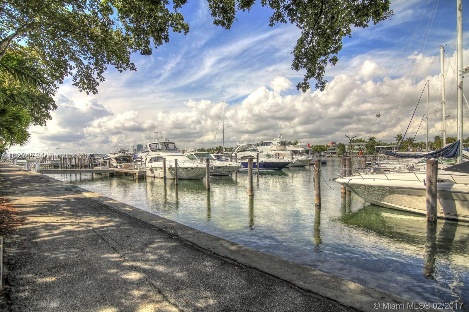 2 Grove Isle Drive, Unit B1708 Miami, FL 33133 - Photo 27 of 30 a view of a lake with boats and trees in the background