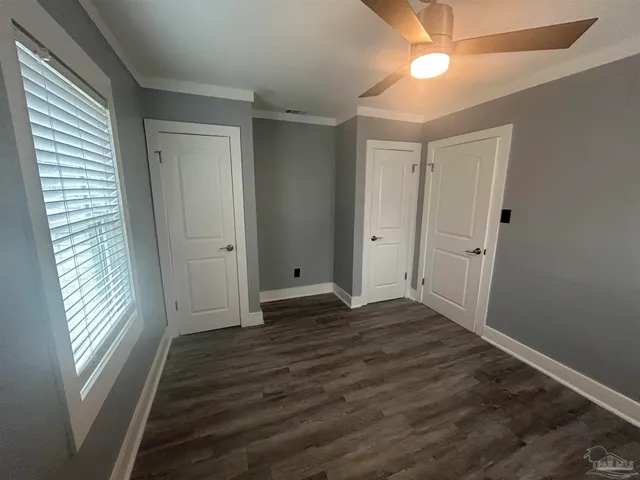 a view of wooden floor and windows in an empty room