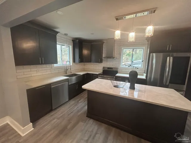 a kitchen with a sink dishwasher a stove and a refrigerator