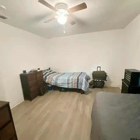 a bedroom with furniture and a mirror