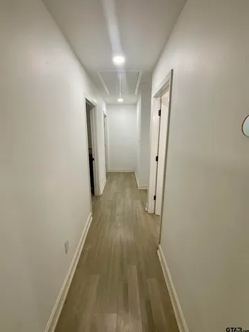 a spacious bedroom with two beds and a chandelier