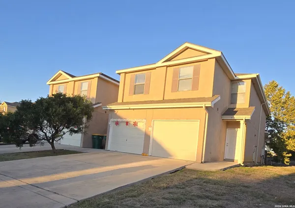 a view of a house with a yard and garage