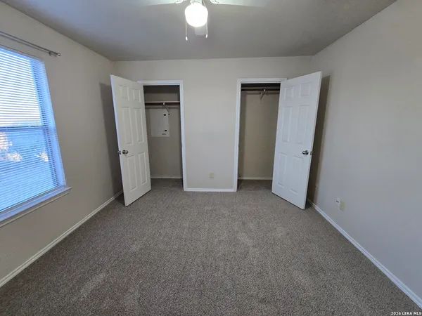 a view of an empty room with a fireplace