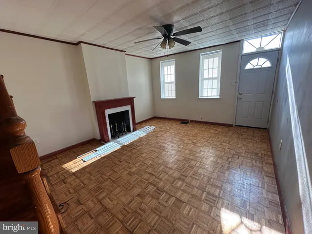 a view of an empty room with window and fireplace