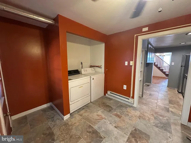 a view of a hallway with closet and a bathroom