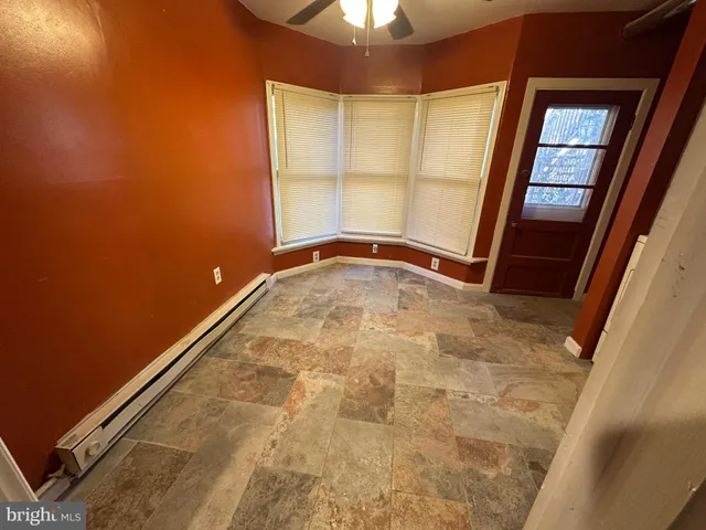 an empty room with a fireplace and painted walls