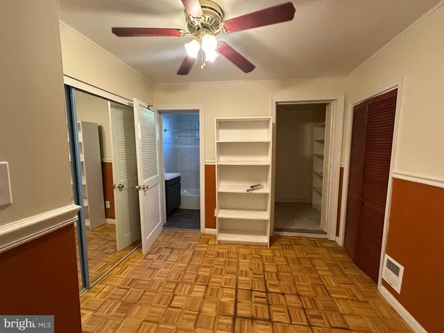 a view of a hallway to rooms