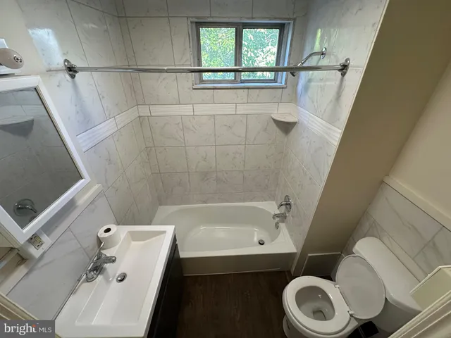 a bathroom with a sink a toilet and bathtub