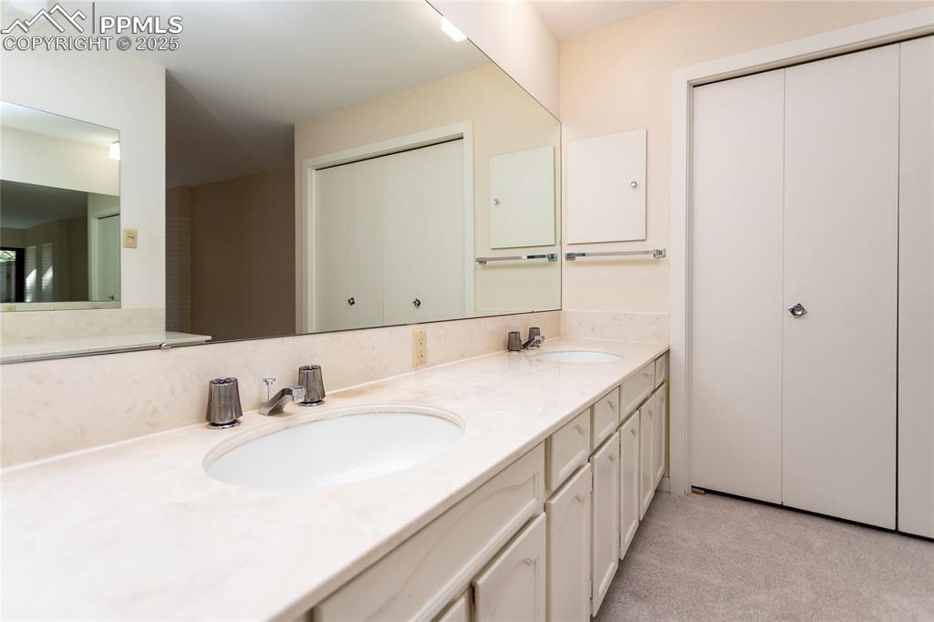 2650 Spring Grove Terrace Colorado Springs, CO 80906 - Photo 20 of 35 Full bathroom featuring double vanity and a closet