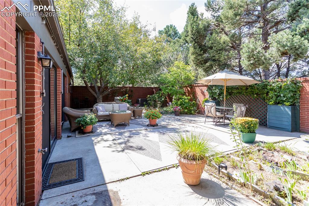 2650 Spring Grove Terrace Colorado Springs, CO 80906 - Photo 26 of 35 Fenced backyard with a patio area and an outdoor hangout area