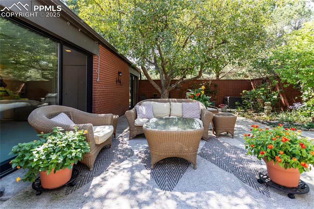 2650 Spring Grove Terrace Colorado Springs, CO 80906 - Photo 27 of 35 Fenced backyard featuring a patio and outdoor lounge area