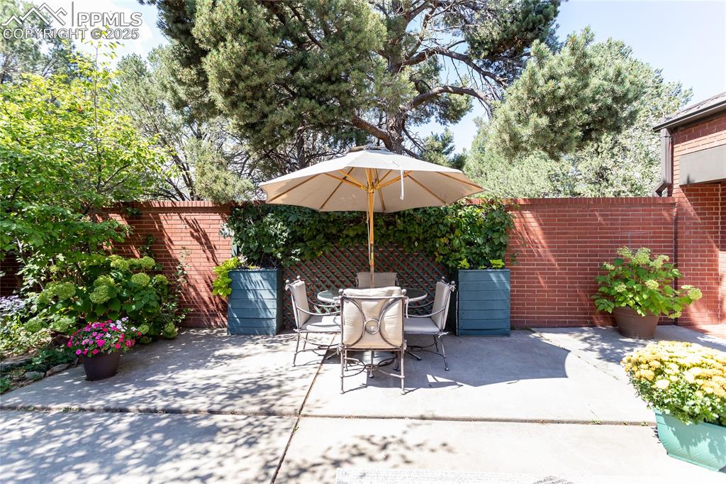 2650 Spring Grove Terrace Colorado Springs, CO 80906 - Photo 28 of 35 Fenced backyard featuring outdoor dining space and a patio area