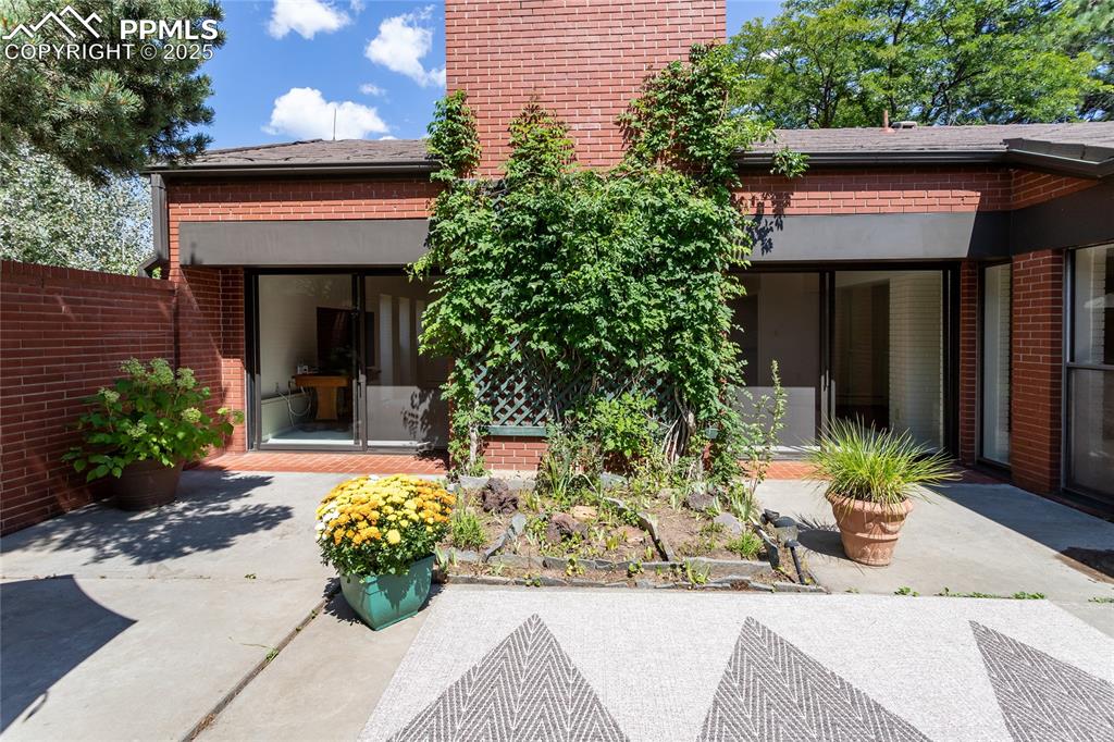 2650 Spring Grove Terrace Colorado Springs, CO 80906 - Photo 29 of 35 Rear view of property featuring brick siding and a patio area