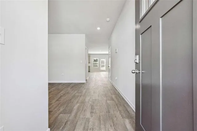 a view of hallway with wooden floor